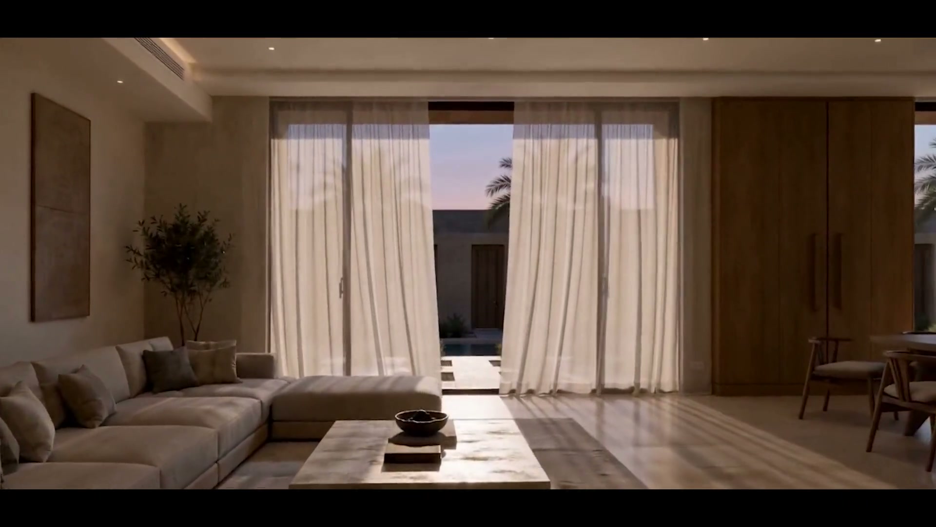 A living room with its curtains drawn back to the afternoon light